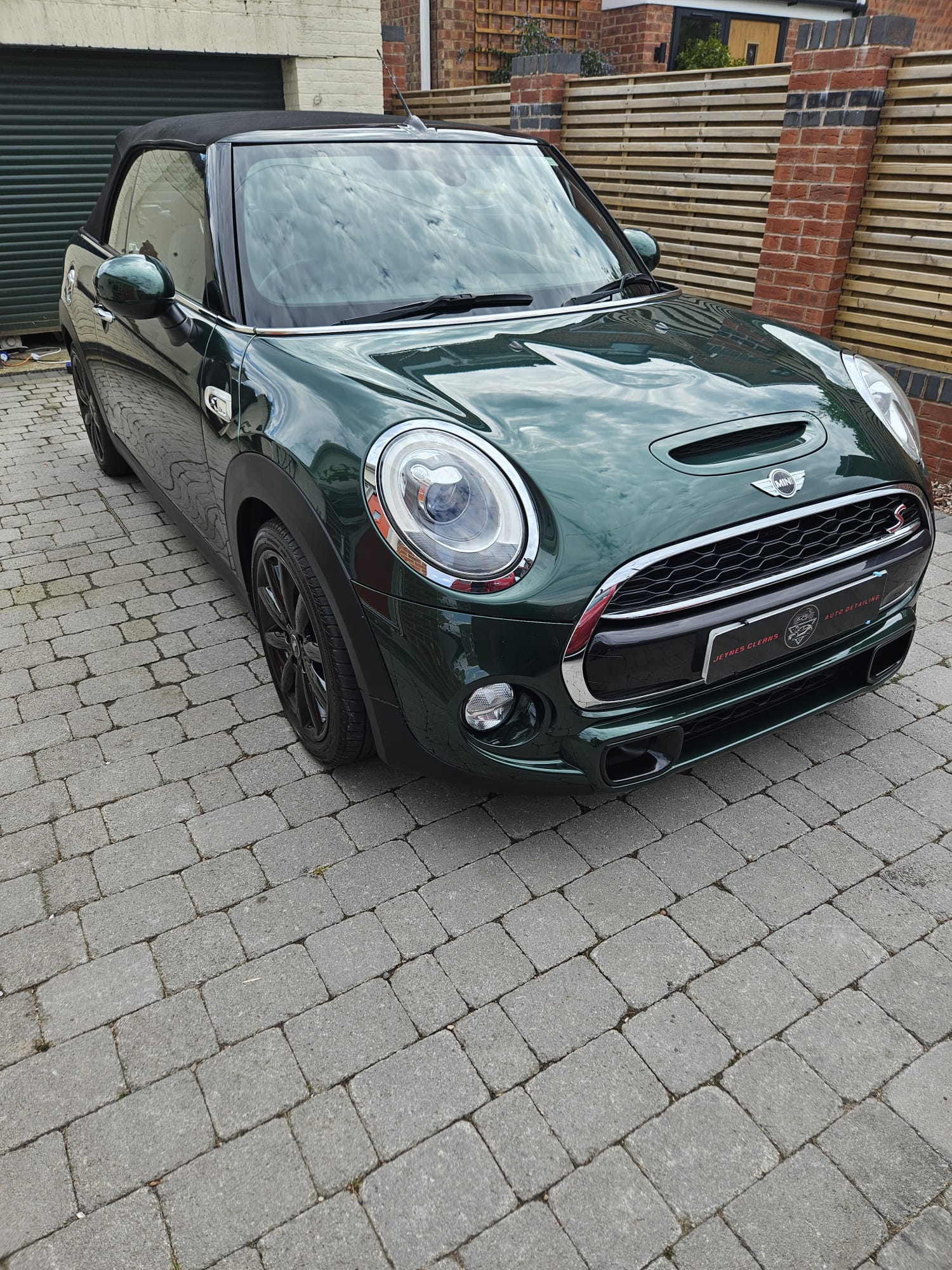 Green Mini Cooper cleaned on a customer's driveway