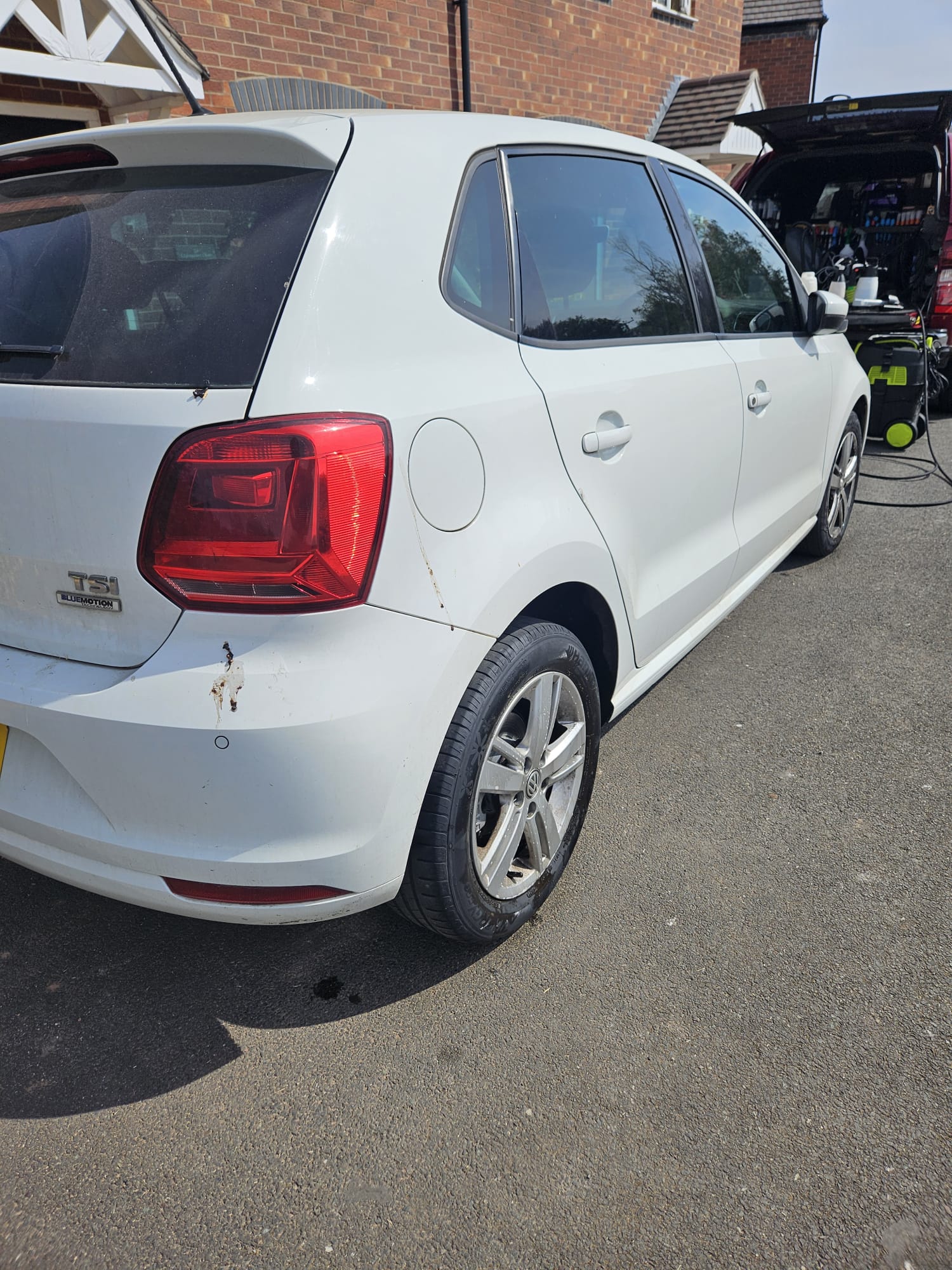 White Volkswagen hatchback before exterior cleaning