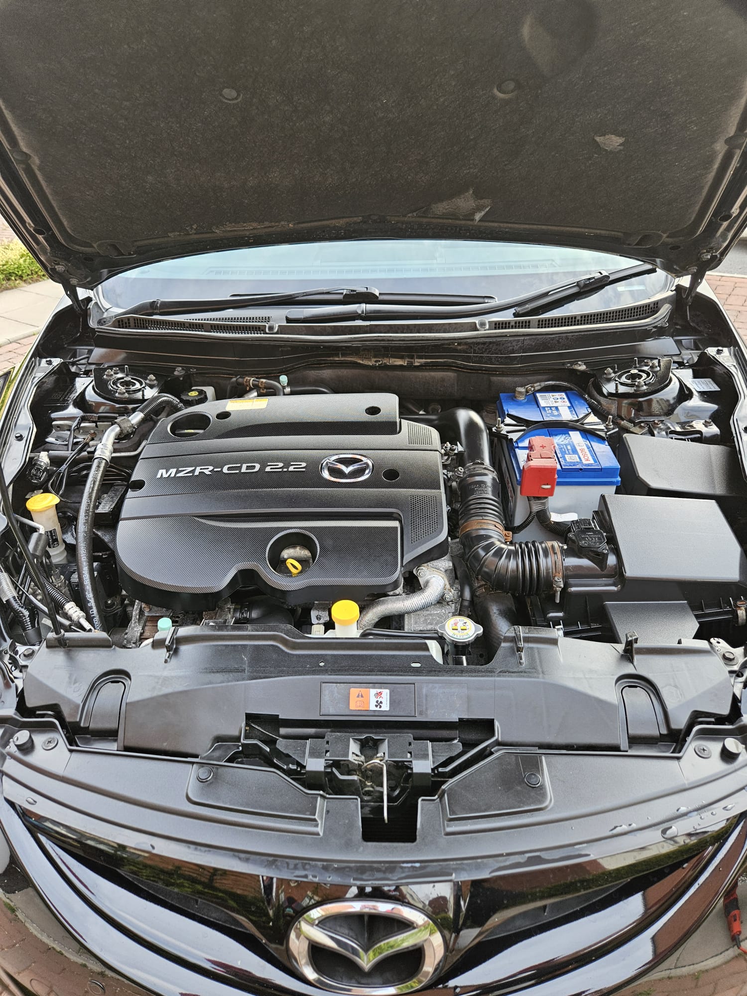 The same Mazda engine bay after cleaning